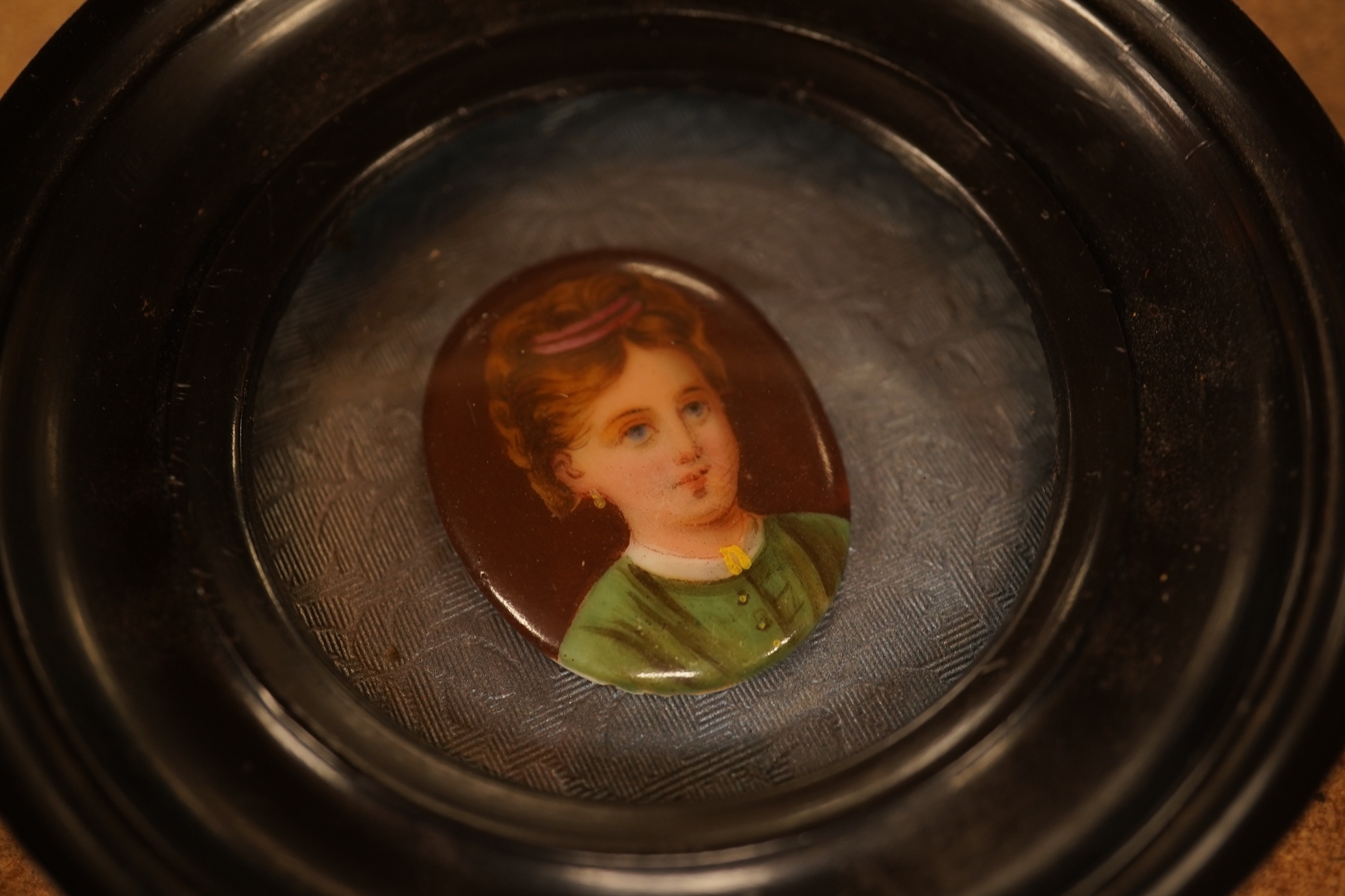 A pair of circular framed oval miniatures on porcelain plaques. Plaques 3.5cm high